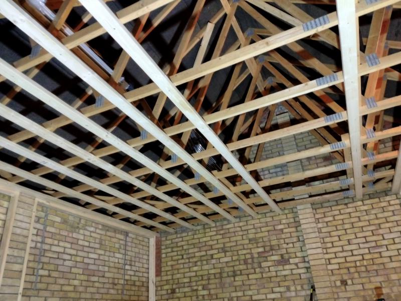 View toward the ceiling; 8 ceiling beams perpendicular to the existing joists are installed, there is a gap for 2 or 3 more