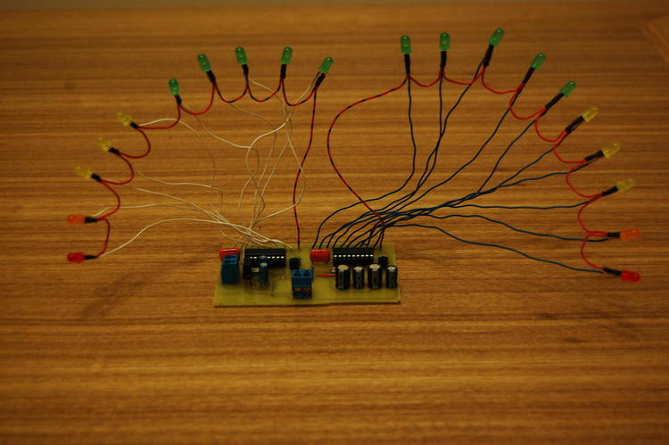 LEDs with lots of wires coming from them form two curves, attached the PCB in the middle