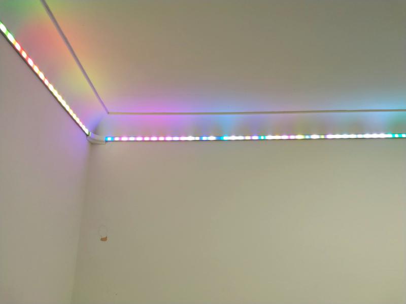 View of a corner with the LED strip lit up. The LEDs show a seemingly random set of colours instead of a smooth rainbow gradient, indicating data issues