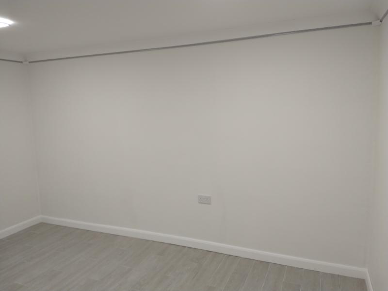 Wide view of rear wall with a slightly off-white colour, all masking tape removed