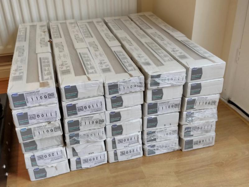 5 Stack of 6 boxes tall each, each containing 6 tiles about a metre long, and roughly 20 centimetres wide.