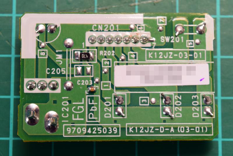 Reverse side of the circuit board retrieved from the air conditioner. Each component has its designators repeated on this this side. There are a couple of surface mount components: R202: a 470 ohm resistor, I think 0805 format; and C203: a capacitor of unkonwn value in what looks to be 0603 or 0402 format.