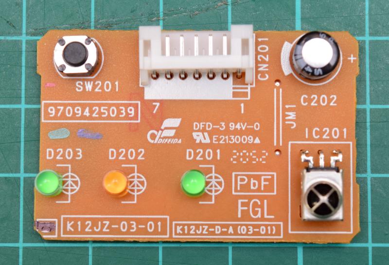 Top side of the circuit board removed from from the air conditioner.  Top left to right to bottom: a push button labeled SW201, a 7-pin horizontal connector labeled CN201, an electrolytic capacitor labeled C202, 3 LEDs in a row: Green: D203, Yellow: D202, Green: D201; and finally an infrared receiver labeled IC201. There are also various identifying numbers all over the board. I believe the most relevant one is K12JZ-03-01