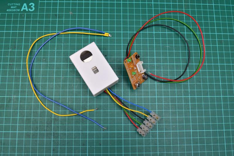 Wired infrared LED, A/C circuit board with wires soldered on, and esp home-ir-box back in its 3d printed box and terminated with screw terminals on the 5 wires, all presented on a work surface