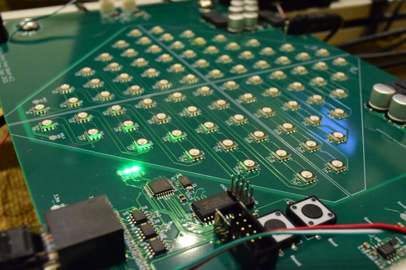 Close up of a board with loads of LEDs in a diamond shape, as well as several chips closer to the camera