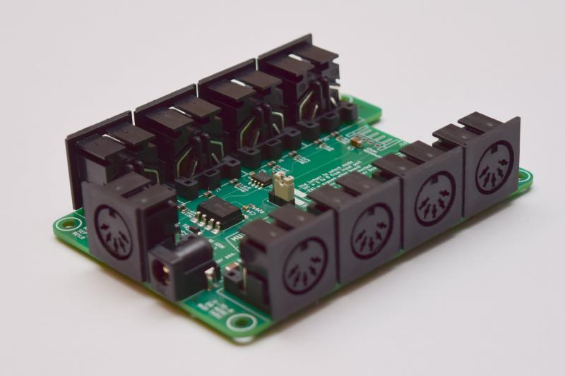 Photo of the circuit board showing a bunch of MIDI connectors and a sparse few components between