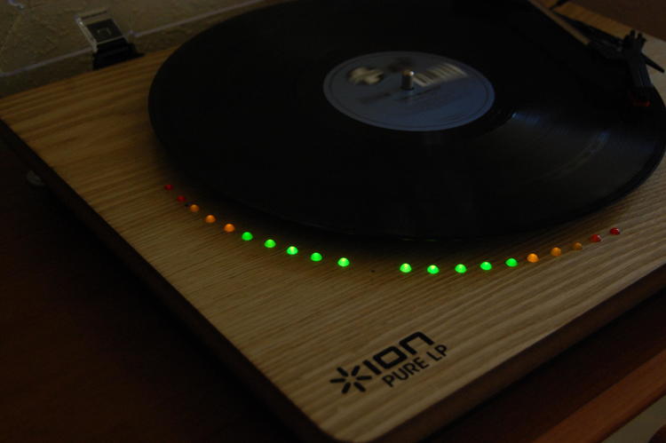 Turntable playing a record, with the LEDs along the diameter of the record partially lighting up