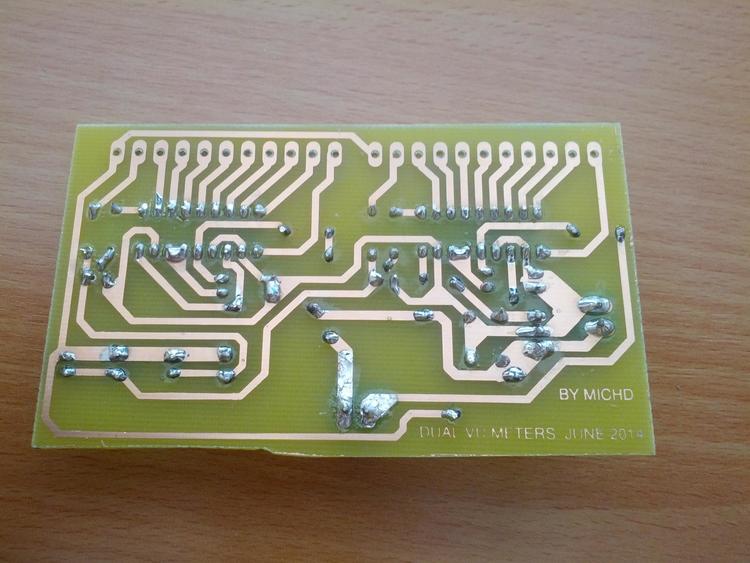 Bottom side of the PCB, with the copper traces showing and actual copper colour. Components have been soldered on somewhat messily